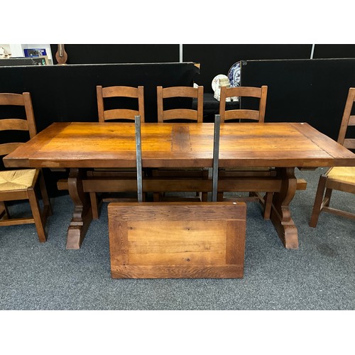 212 - An oak plank-top trestle dining table, 71.5cm high x 219.5cm long x 85cm wide, and a conforming set ... 