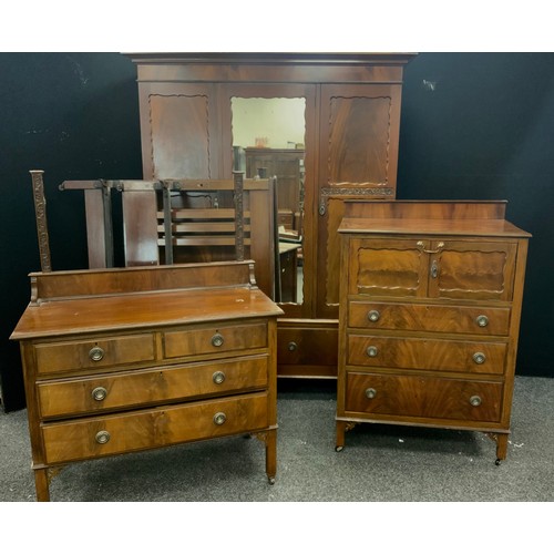 214 - An early 20th century mahogany bedroom suite, comprising triple wardrobe, tall boy, dressing chest, ... 