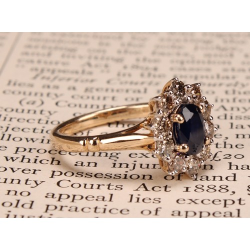 245 - A 9ct gold sapphire and diamond cluster ring, oval sapphire 1.00ct approx, round brilliant cut diamo... 