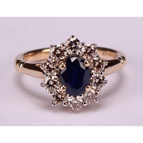 245 - A 9ct gold sapphire and diamond cluster ring, oval sapphire 1.00ct approx, round brilliant cut diamo... 