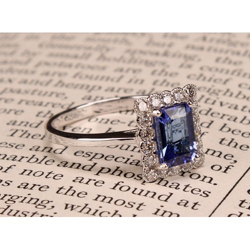 248 - An 18ct white gold ring, set with emerald cut tanzanite and round brilliant cut diamonds, tanzanite ... 