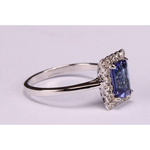 248 - An 18ct white gold ring, set with emerald cut tanzanite and round brilliant cut diamonds, tanzanite ... 