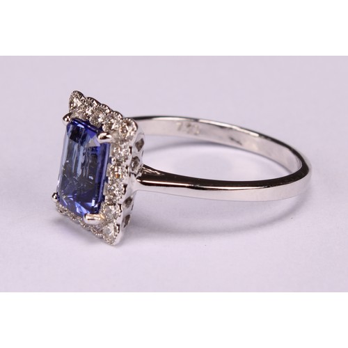 248 - An 18ct white gold ring, set with emerald cut tanzanite and round brilliant cut diamonds, tanzanite ... 