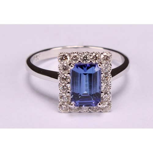 248 - An 18ct white gold ring, set with emerald cut tanzanite and round brilliant cut diamonds, tanzanite ... 