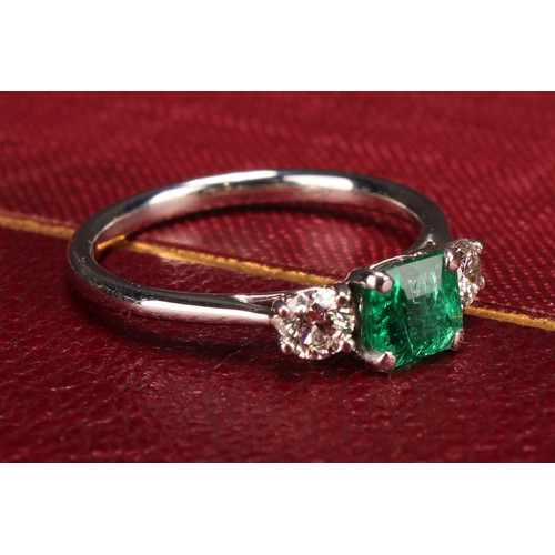 249 - An 18ct white gold diamond and emerald three stone ring, emerald 0.66ct, diamonds 0.37ct, size L