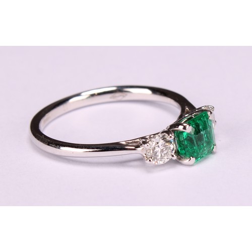 249 - An 18ct white gold diamond and emerald three stone ring, emerald 0.66ct, diamonds 0.37ct, size L