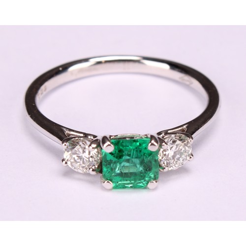 249 - An 18ct white gold diamond and emerald three stone ring, emerald 0.66ct, diamonds 0.37ct, size L