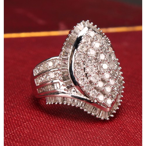 254 - A Large 9ct white gold navette swirl diamond cluster dress ring set with round brilliant and baguett... 