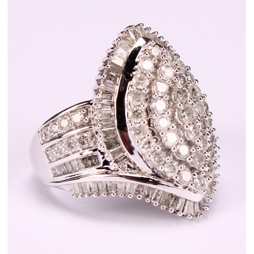 254 - A Large 9ct white gold navette swirl diamond cluster dress ring set with round brilliant and baguett... 