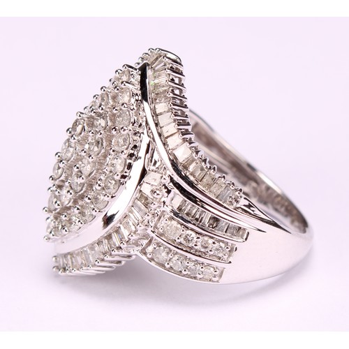 254 - A Large 9ct white gold navette swirl diamond cluster dress ring set with round brilliant and baguett... 