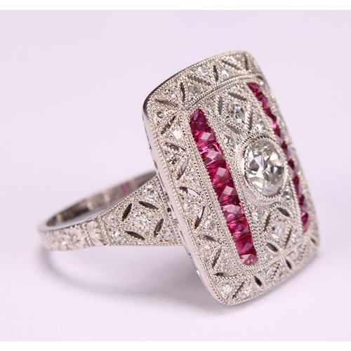 255 - A Large Art Deco style platinum ring set with old-cut and eight-cut diamonds and rubies with milligr... 