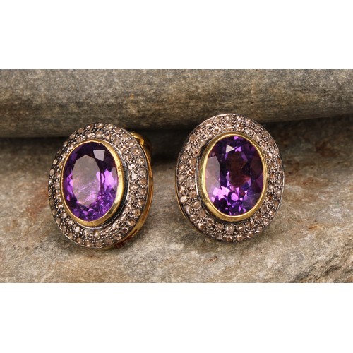 257 - A pair of cufflinks in yellow metal set with oval amethysts surrounded by round cut diamonds, the al... 