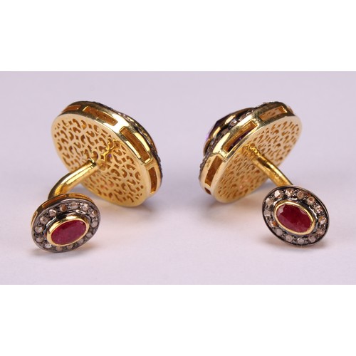 257 - A pair of cufflinks in yellow metal set with oval amethysts surrounded by round cut diamonds, the al... 