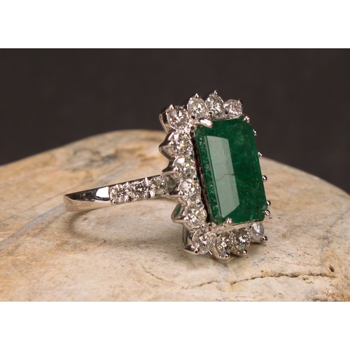 260 - An 18ct white gold emerald and diamond cluster ring, step-cut emerald, 6.01ct, round brilliant cut d... 