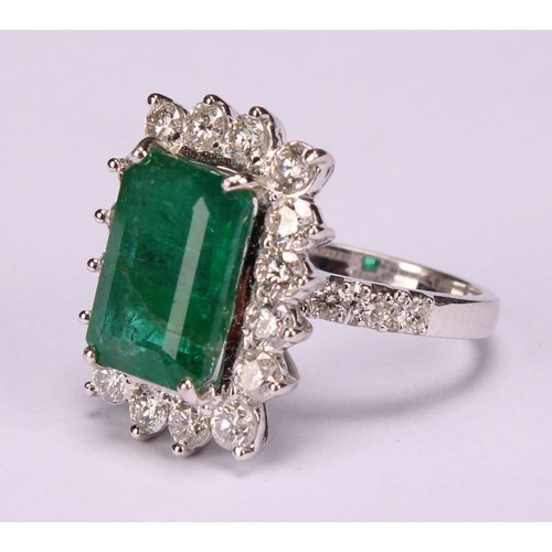 260 - An 18ct white gold emerald and diamond cluster ring, step-cut emerald, 6.01ct, round brilliant cut d... 