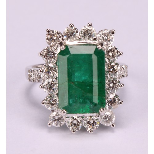 260 - An 18ct white gold emerald and diamond cluster ring, step-cut emerald, 6.01ct, round brilliant cut d... 