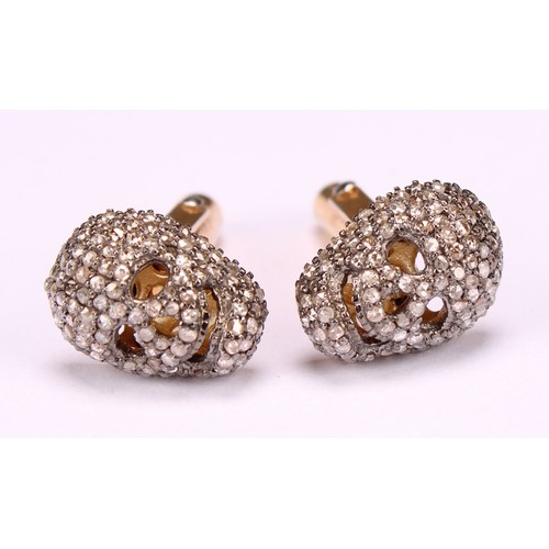 264 - The Macabre - a pair of diamond encrusted novelty cufflinks, as skulls, each set with rose cut stone... 