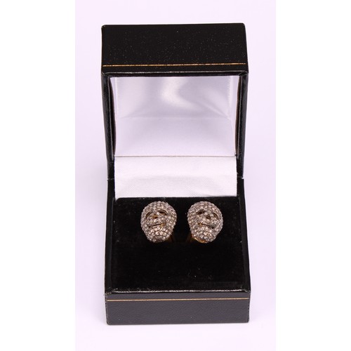 264 - The Macabre - a pair of diamond encrusted novelty cufflinks, as skulls, each set with rose cut stone... 