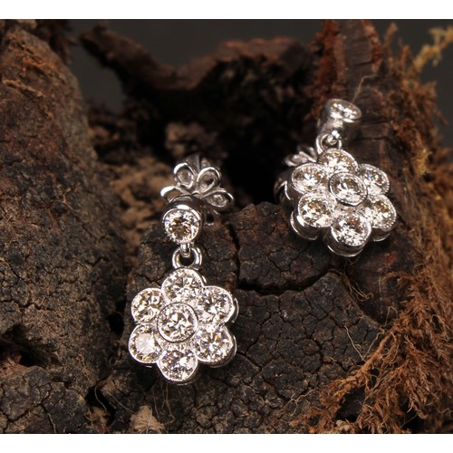 266 - A Pair of 18ct white gold daisy-style diamond set cluster drop earrings, the central round brilliant... 