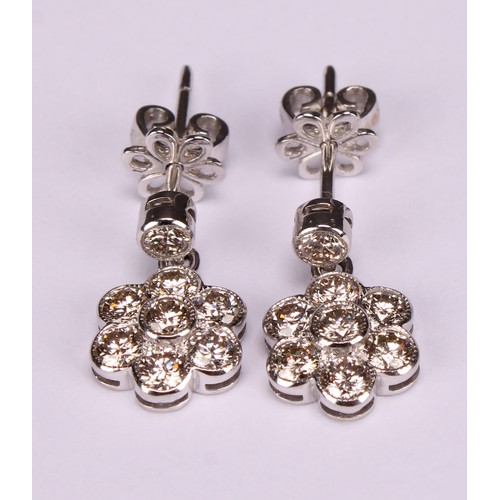 266 - A Pair of 18ct white gold daisy-style diamond set cluster drop earrings, the central round brilliant... 