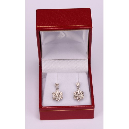 266 - A Pair of 18ct white gold daisy-style diamond set cluster drop earrings, the central round brilliant... 