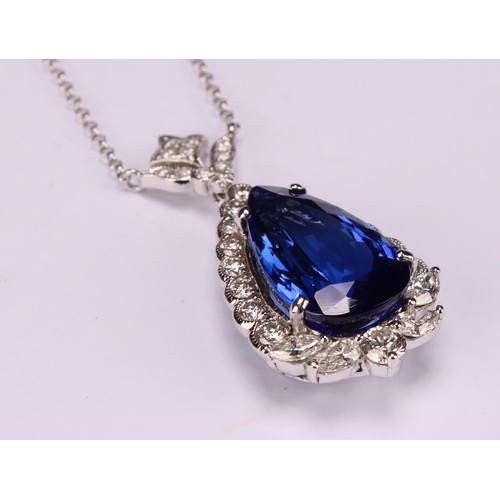 268 - An 18ct white gold pendant, set with a pear shaped tanzanite surrounded by round brilliant, pear and... 