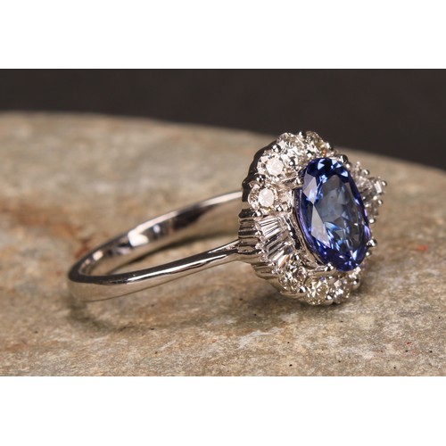 271 - An 18ct white gold oval tanzanite and diamond cluster ring. oval Tanzanite 1.34ct. Round brilliant c... 