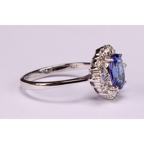 271 - An 18ct white gold oval tanzanite and diamond cluster ring. oval Tanzanite 1.34ct. Round brilliant c... 