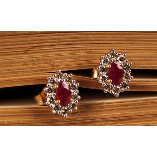 273 - A pair of 9ct yellow and white gold oval ruby and RBC diamond cluster studs, boxed. Rubies 0.62ct. D... 