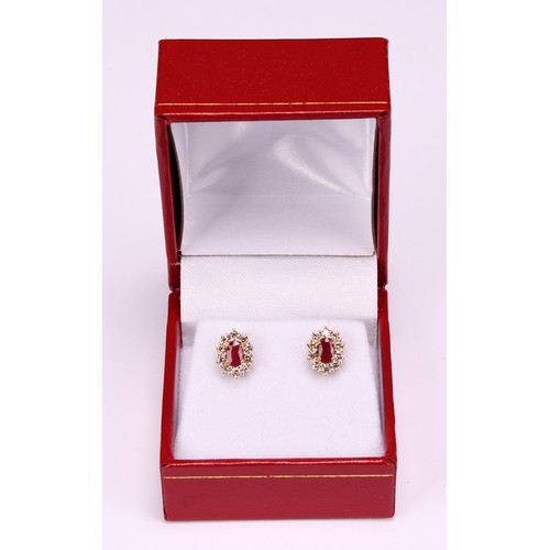 273 - A pair of 9ct yellow and white gold oval ruby and RBC diamond cluster studs, boxed. Rubies 0.62ct. D... 