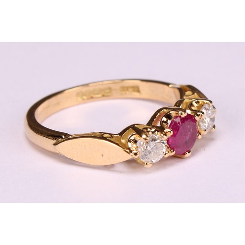 277 - An 18ct gold three stone diamond and ruby ring, diamonds 0.34ct, ruby 0.58ct, size M