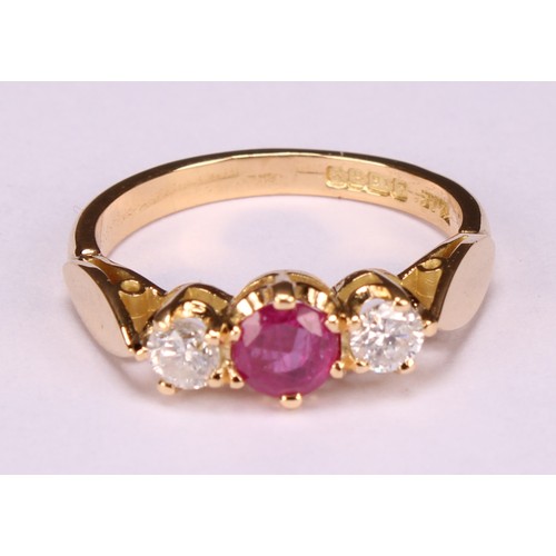 277 - An 18ct gold three stone diamond and ruby ring, diamonds 0.34ct, ruby 0.58ct, size M