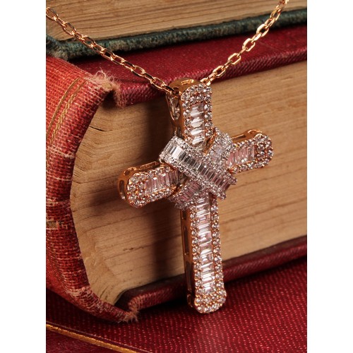 281 - An 18ct rose gold and diamond cross pendant, the whole encrusted with baguette and round brilliant c... 