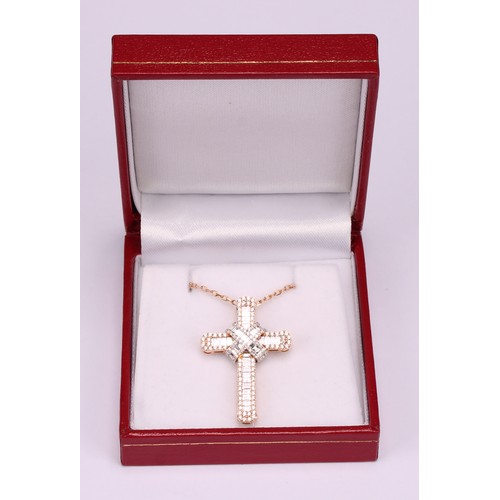 281 - An 18ct rose gold and diamond cross pendant, the whole encrusted with baguette and round brilliant c... 