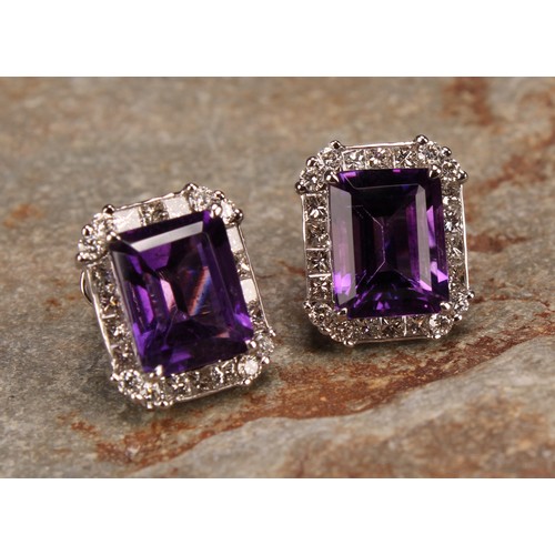 283 - A pair of 18ct white gold stud earrings, set with step-cut amethysts surrounded by round brilliant a... 