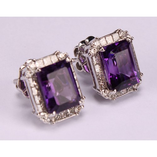 283 - A pair of 18ct white gold stud earrings, set with step-cut amethysts surrounded by round brilliant a... 