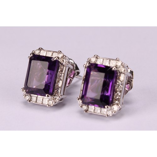 283 - A pair of 18ct white gold stud earrings, set with step-cut amethysts surrounded by round brilliant a... 