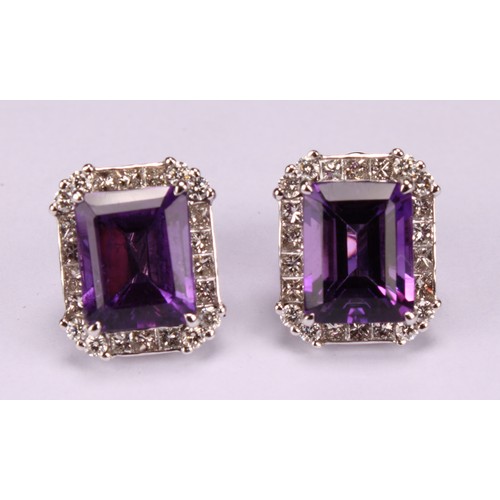 283 - A pair of 18ct white gold stud earrings, set with step-cut amethysts surrounded by round brilliant a... 