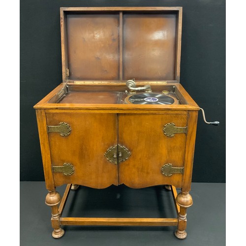 150A - A Meritone gramophone, with floor-standing oak cabinet, 87.5cm high x 78.5cm wide x 49cm deep, c.193... 