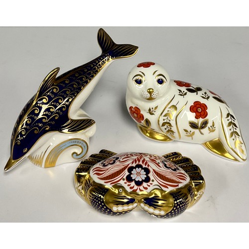 12 - A Royal Crown Derby paperweight, Blue Dolphin, 17cm long, gold stopper; others, Seal, 13cm long, gol... 