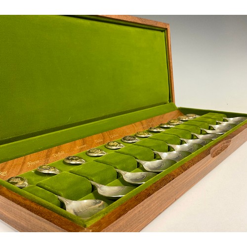 72 - A collection of twelve silver teaspoons, The Royal Horticultural Society Flower Spoons, each oval gi... 