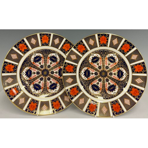 73 - A pair of Royal Crown Derby 1128 Imari pattern dinner plates, 27cm diameter, first quality