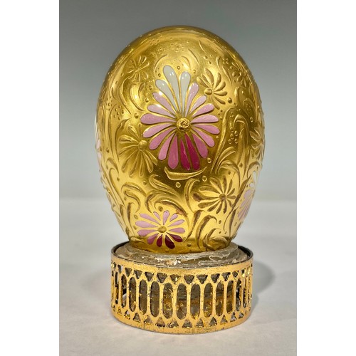 78 - A gilt porcelain egg, decorated with raised gilt and pink enamel flowers, possibly by Stefan Nowacki... 