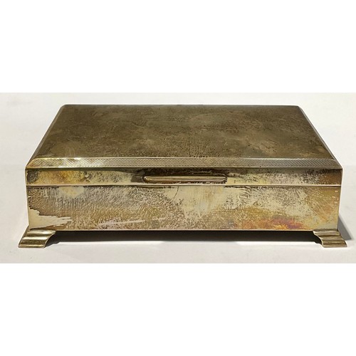 86 - A silver rectangular cigarette box, bracket feet, 17cm wide, Sheffield 1972