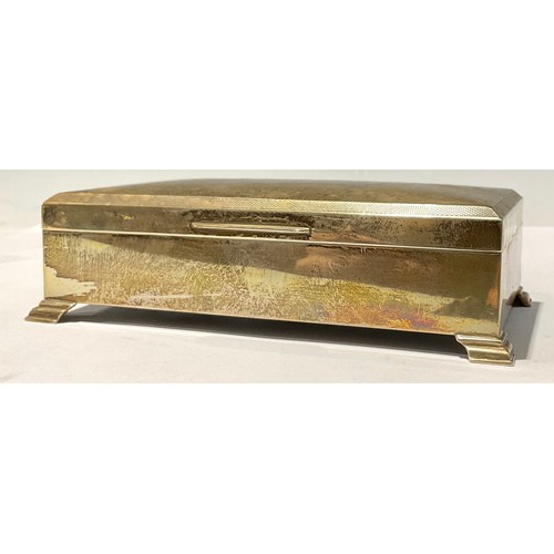 86 - A silver rectangular cigarette box, bracket feet, 17cm wide, Sheffield 1972