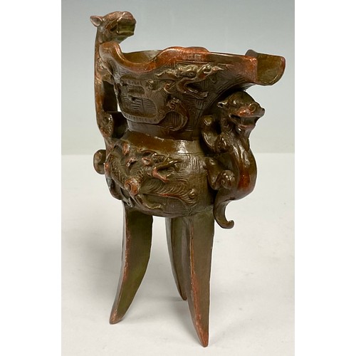 92 - A 20th century Chinese bronze tripod Jue cup, 13cm high, 11.5cm wide