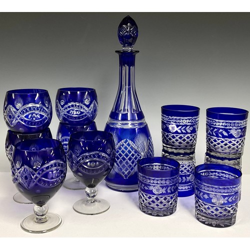 129 - A Bohemian glass blue flashed decanter and stopper, 36cm; six conforming wine glasses, 14cm; six con... 