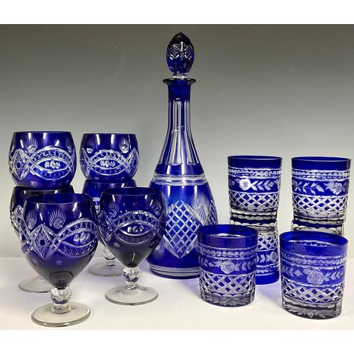 129 - A Bohemian glass blue flashed decanter and stopper, 36cm; six conforming wine glasses, 14cm; six con... 