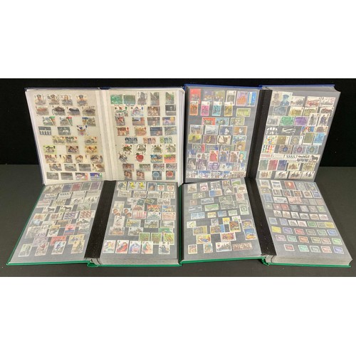 157 - Stamps - four large 32-sided stock books filled with GB and World stamps, thousands of stamps