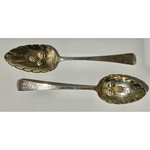 173 - A pair of George III silver embossed berry spoons, gilt bowls, London 1807, 109g